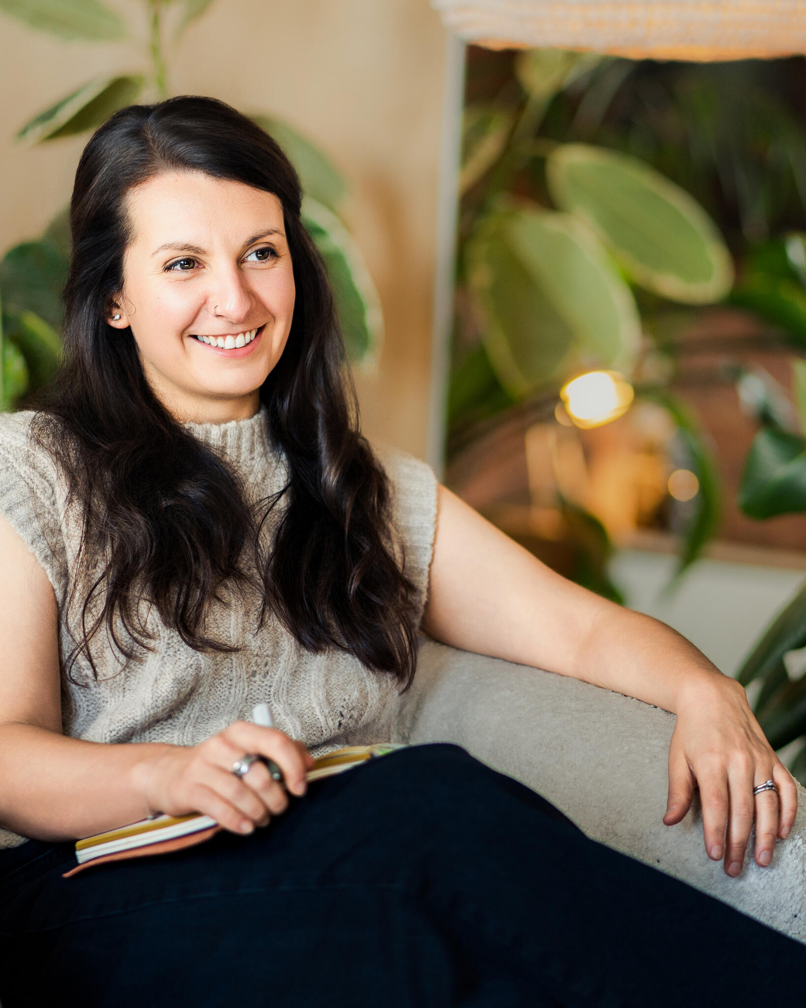 Brownyn running a coaching session Image of Bronwyn Benstead sat in a chair listening to a coaching client